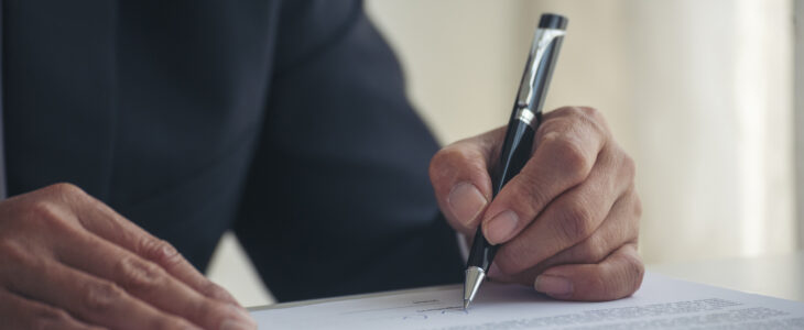 Asian business man using pen signing on new contract to starting projects in conference room. Close up manager businessman hands sign contract working meeting. Business agreement concepts.