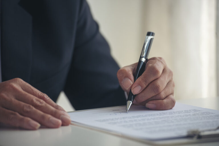 Asian business man using pen signing on new contract to starting projects in conference room. Close up manager businessman hands sign contract working meeting. Business agreement concepts.