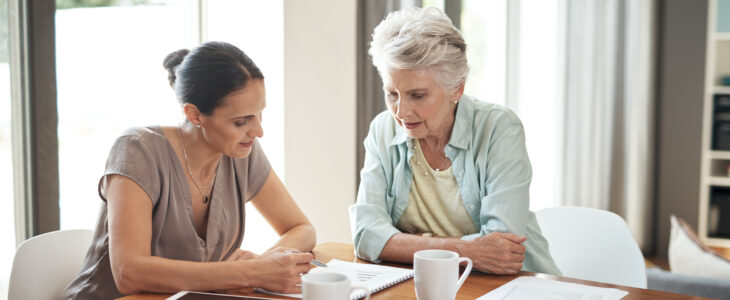 Cropped shot of an attractive young woman assisting her elderly mother with her finances at home