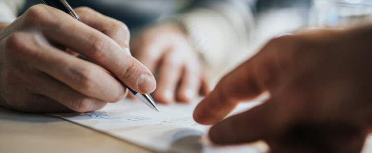 Lawyer shakes hand with client over a trust