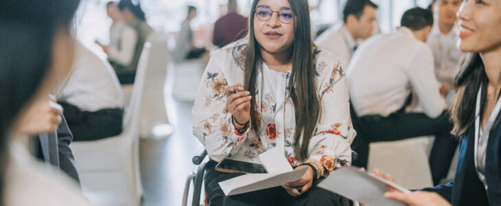 Woman speaking to people in a wheelchair