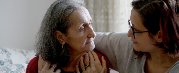 Woman hugging her elderly mother