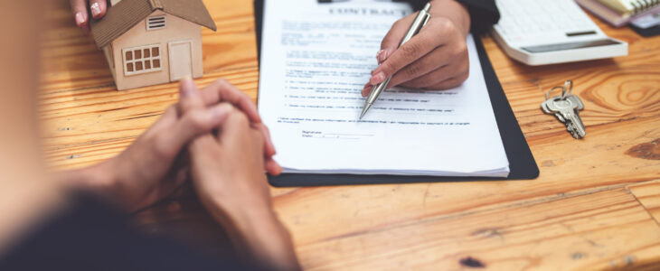 Female lawyer asking a client to read the contract before signing to agree to estate plan.