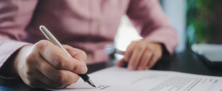 businesswoman signing an official document